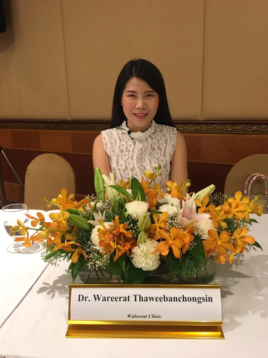 Dr. Waleerat seated behind her Waleerat Clinic nameplate at the 2017 LDK workshop