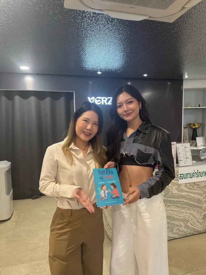 Dr. Waleerat with influencer holding Thread of Love book at VERZO Clinic